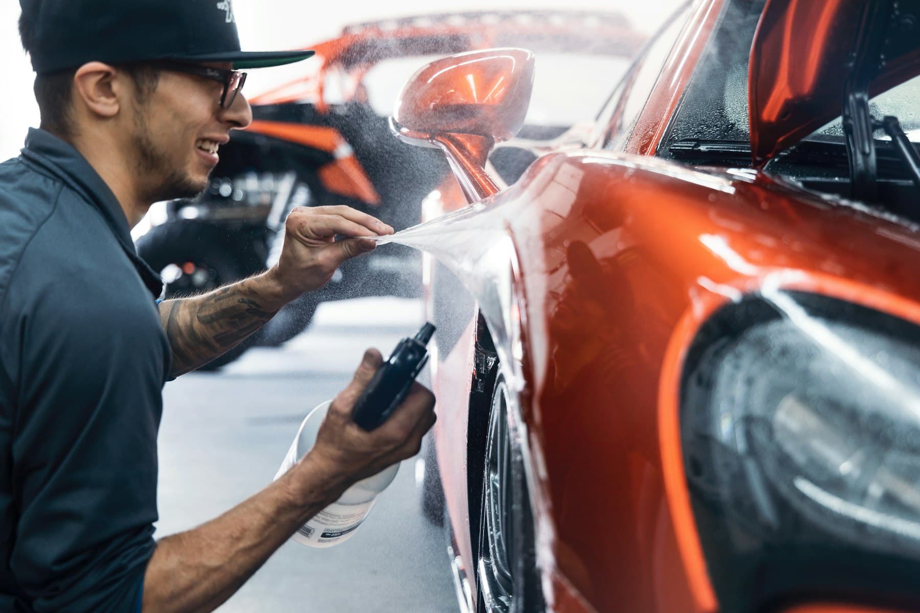 Vehicle paint being waxed during a professional car detailing service